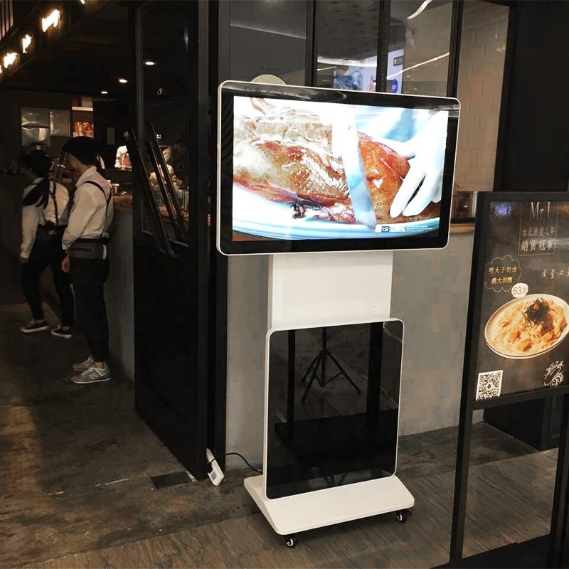 Qtenboard digital signage in restaurant, rotating advertising display showing food menu and promotions.